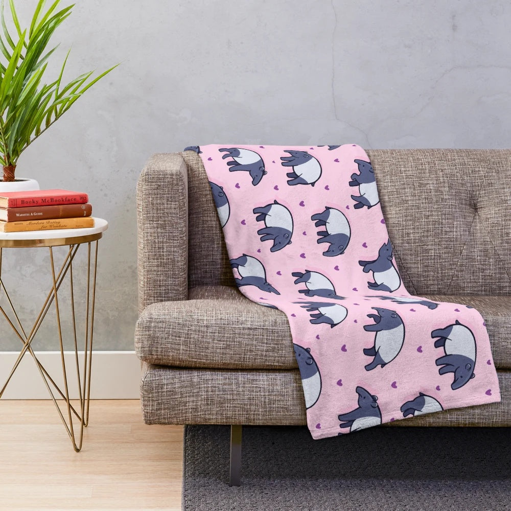 Soft and cuddly plush blanket featuring a cute tapir with a heart pattern design
