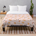 Soft pink plush blanket featuring cute cartoon illustrations of Nova Scotia duck tolling retriever puppies and mallard ducklings