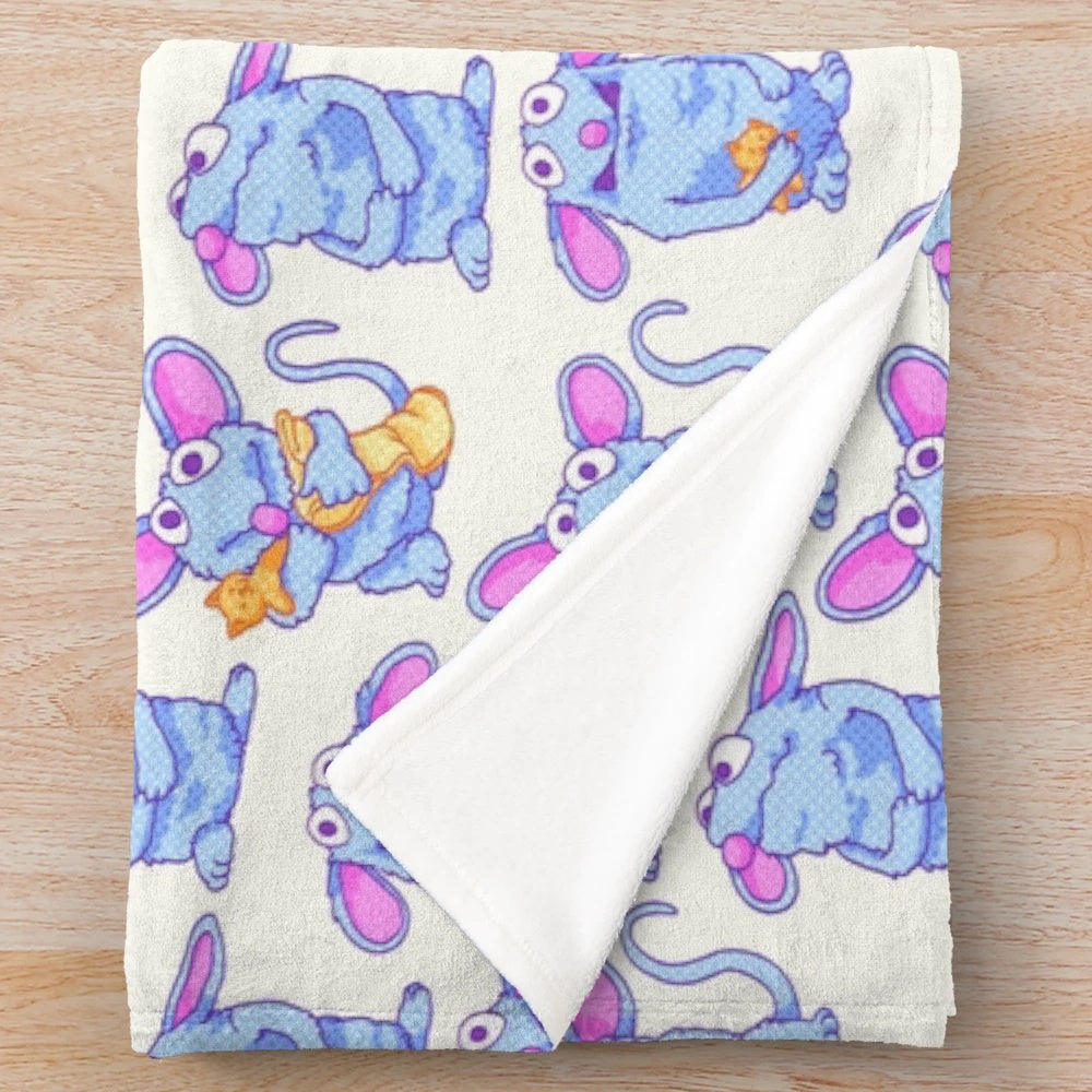 Tutter the blue mouse from Bear in the Big Blue House on a soft, plush blanket