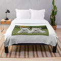 Soft and cuddly West Highland Terrier puppies on a plush blanket