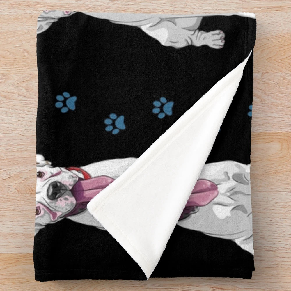 White boxer dog on a cozy plush blanket