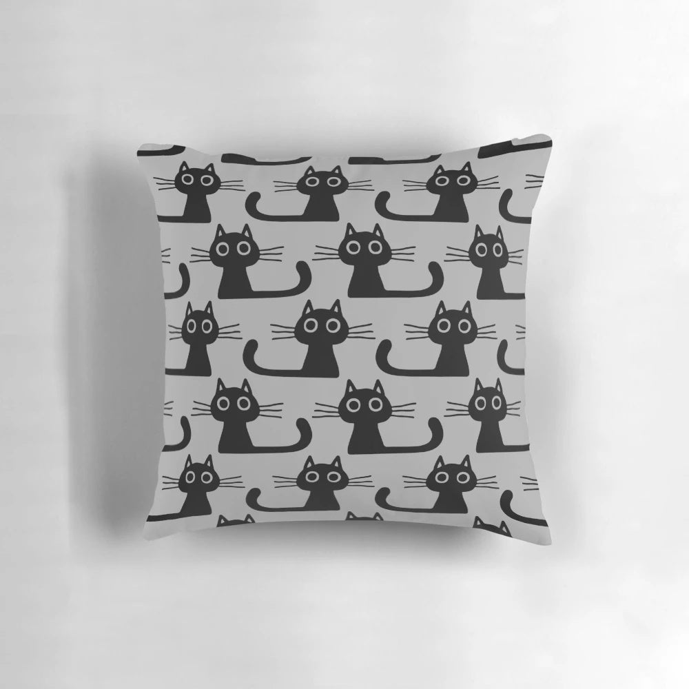 Soft, plush black kitten pillow with wide eyes and cute expression