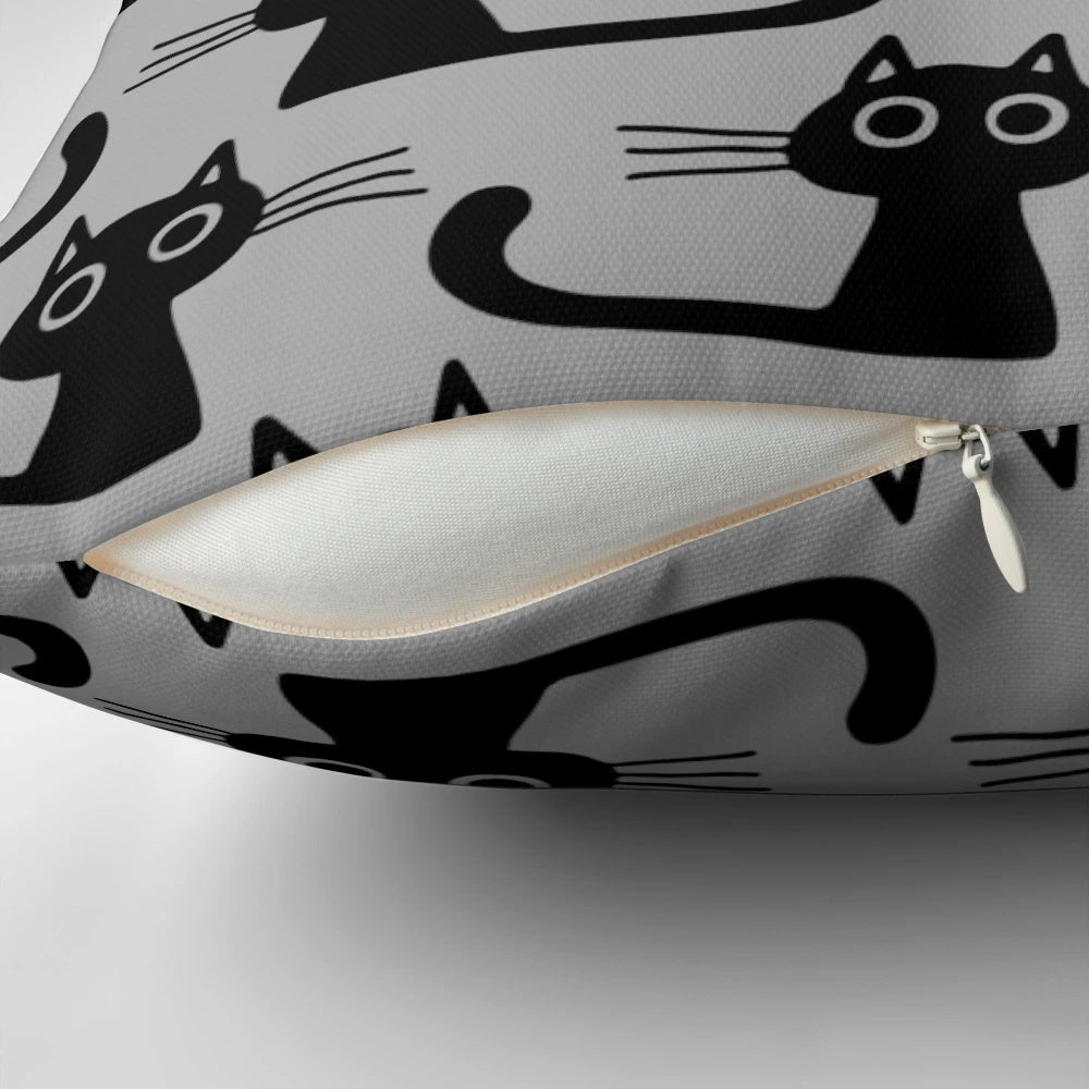 Soft, plush black kitten pillow with wide eyes and cute expression