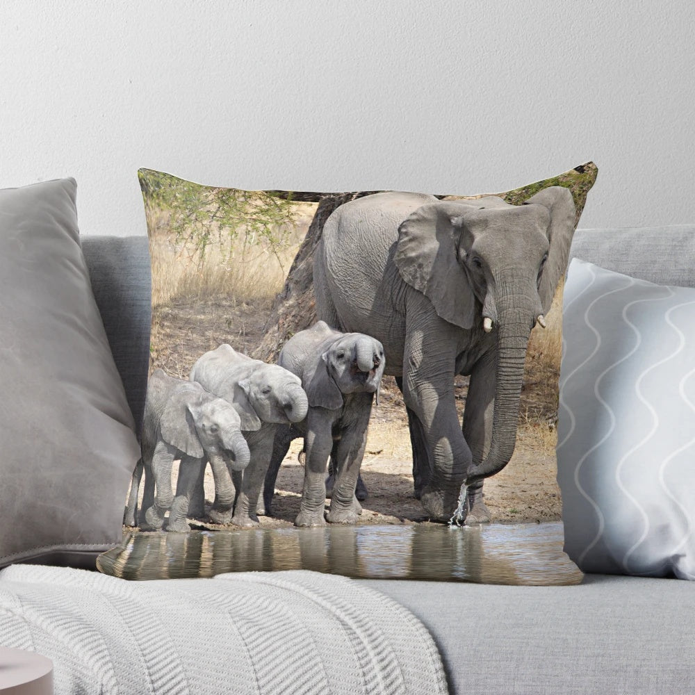 Soft, plush elephant pillow featuring a mother elephant and her baby calves in a serene, natural setting.