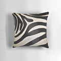Decorative pillow featuring a vibrant black and white zebra stripe pattern, perfect for an African-inspired home decor.