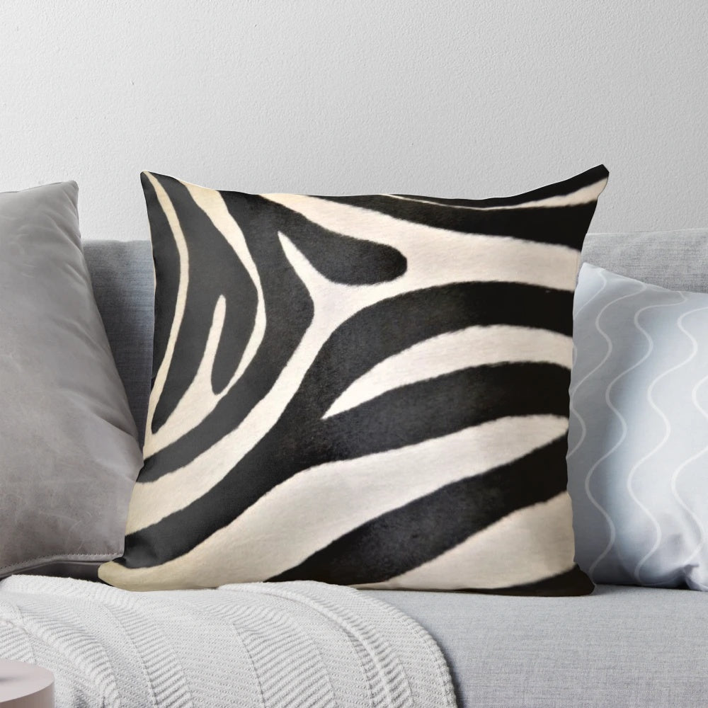 Decorative pillow featuring a vibrant black and white zebra stripe pattern, perfect for an African-inspired home decor.