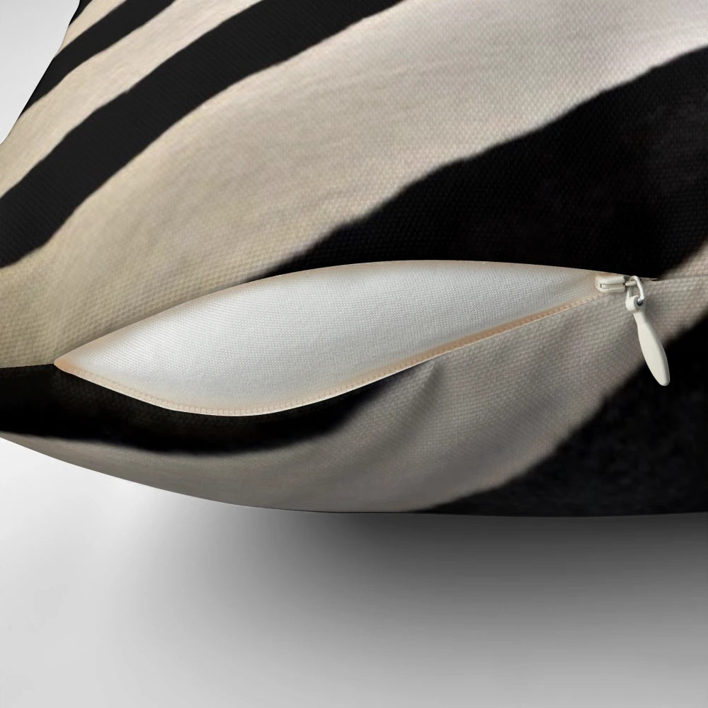 Decorative pillow featuring a vibrant black and white zebra stripe pattern, perfect for an African-inspired home decor.