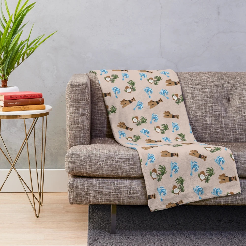 Airedale Terrier dog wearing sunglasses on a plush blanket with a summer pattern of sea waves and coconut palm trees