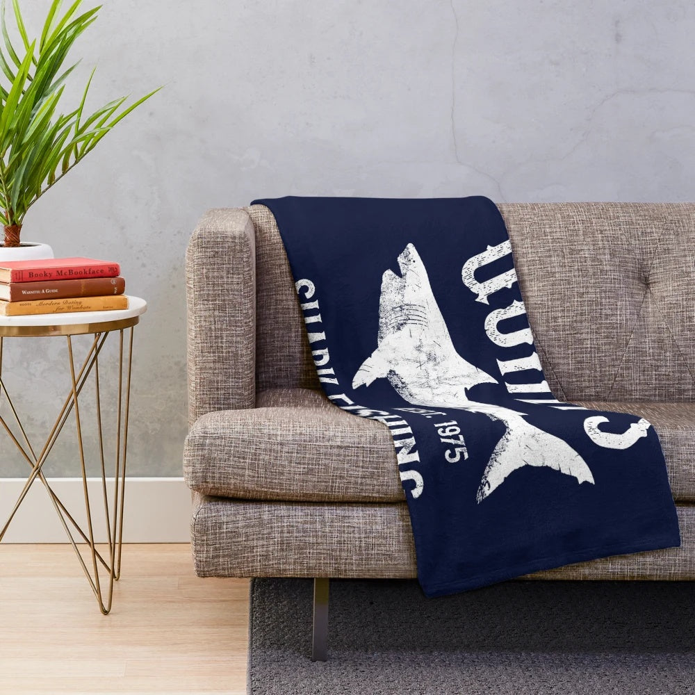 Vintage-style plush blanket inspired by the classic movie Jaws, featuring a shark fishing scene