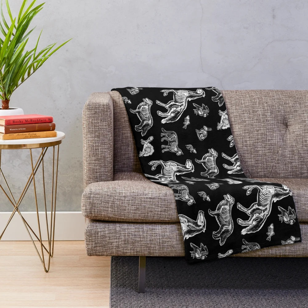 Plush blanket featuring an x-ray anatomy design of animal bones and skeletons