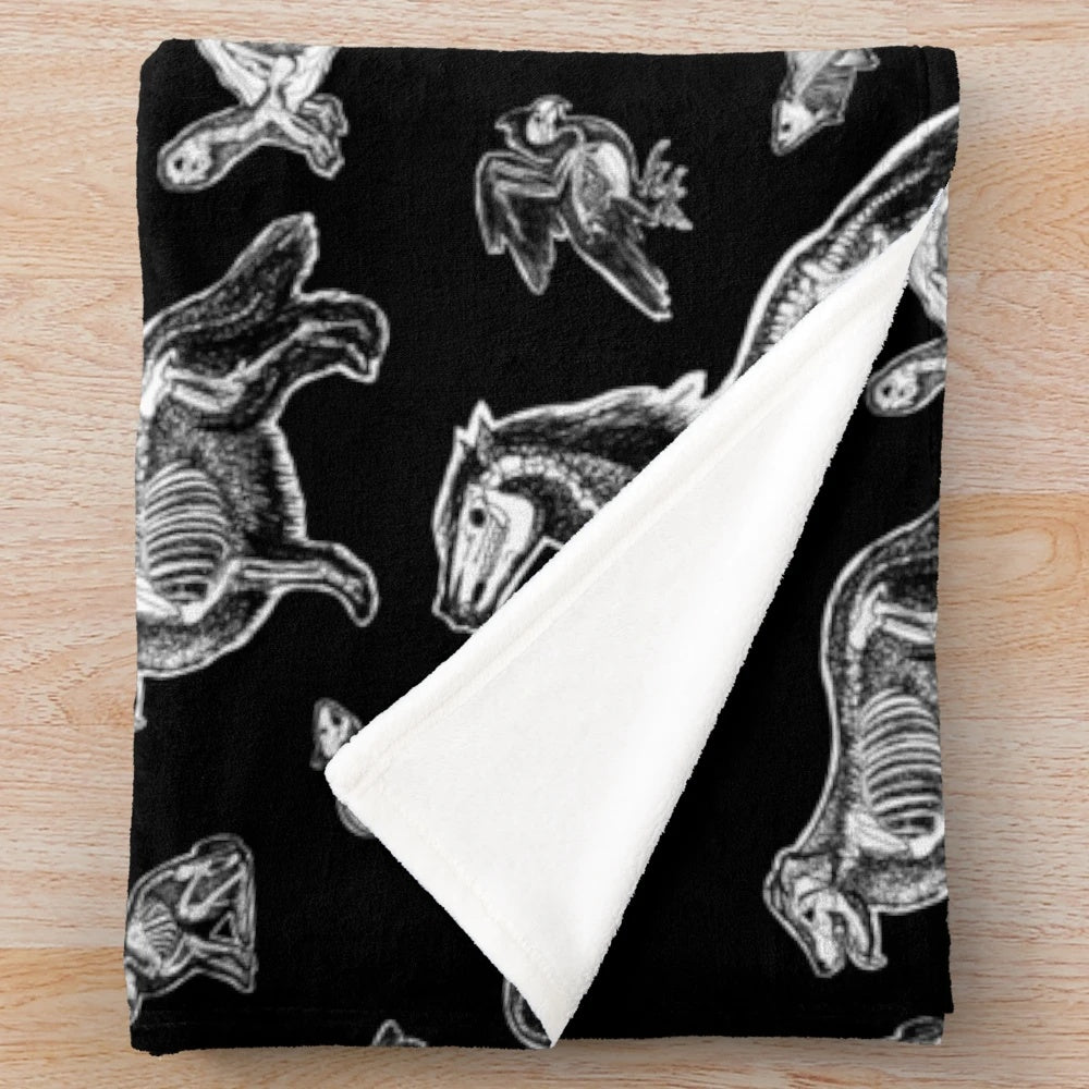 Plush blanket featuring an x-ray anatomy design of animal bones and skeletons