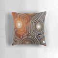 Pillow featuring contemporary Aboriginal art with dots, curved lines, and earthy colors that conveys stories and spirituality.