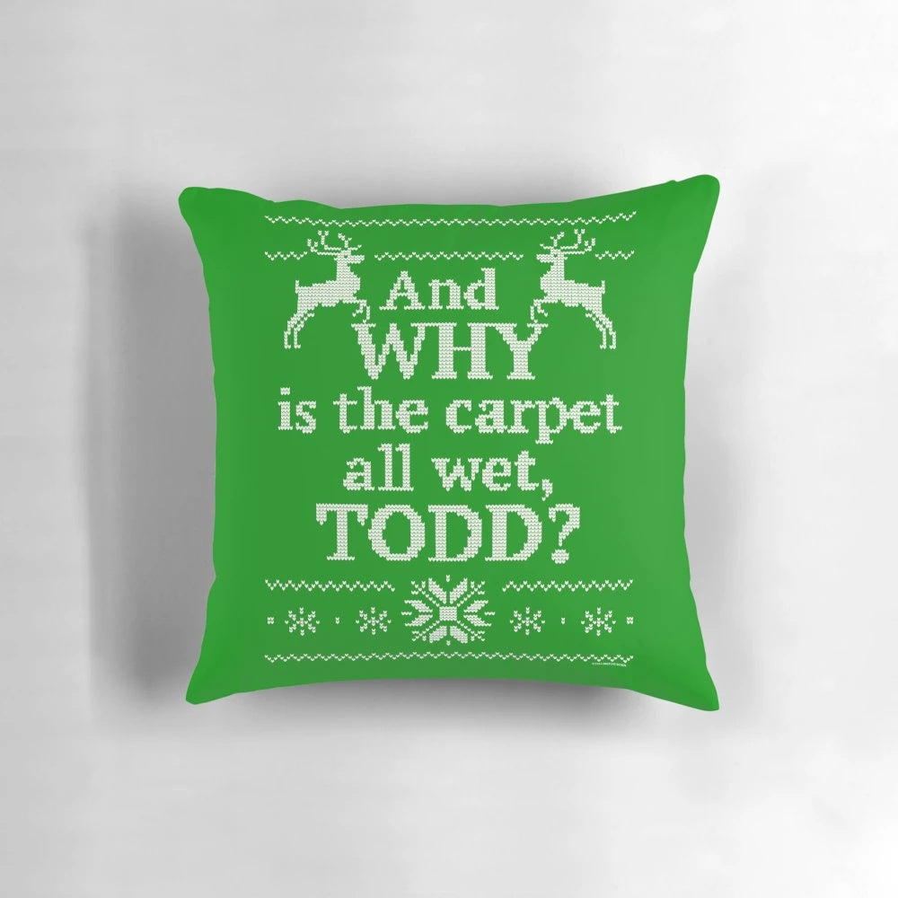 A vintage-style decorative pillow featuring the iconic "And Why Is the Carpet All Wet, Todd?" quote from the beloved Christmas comedy movie "Christmas Vacation".