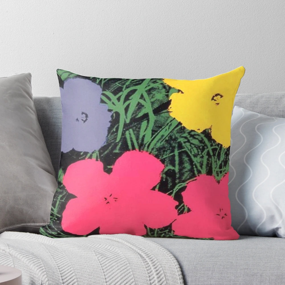 Colorful floral pillow with pink and yellow flowers in the style of Andy Warhol's pop art paintings