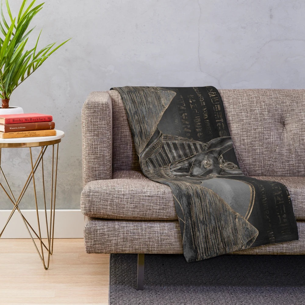 Plush blanket featuring the Egyptian god Anubis and a desert landscape with pyramids