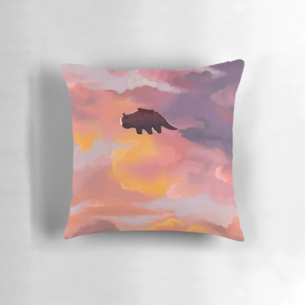 Appa the flying bison from Avatar the Last Airbender depicted in a sunset sky on a decorative pillow