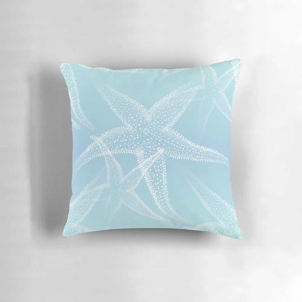Aqua blue beach-themed pillow with white starfish design