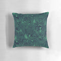 A plush, decorative pillow featuring a striking green pattern inspired by arachnids and other natural elements.