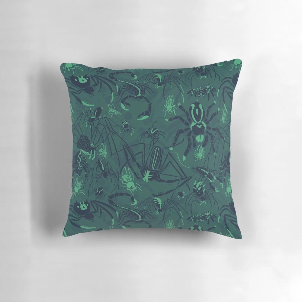 A plush, decorative pillow featuring a striking green pattern inspired by arachnids and other natural elements.