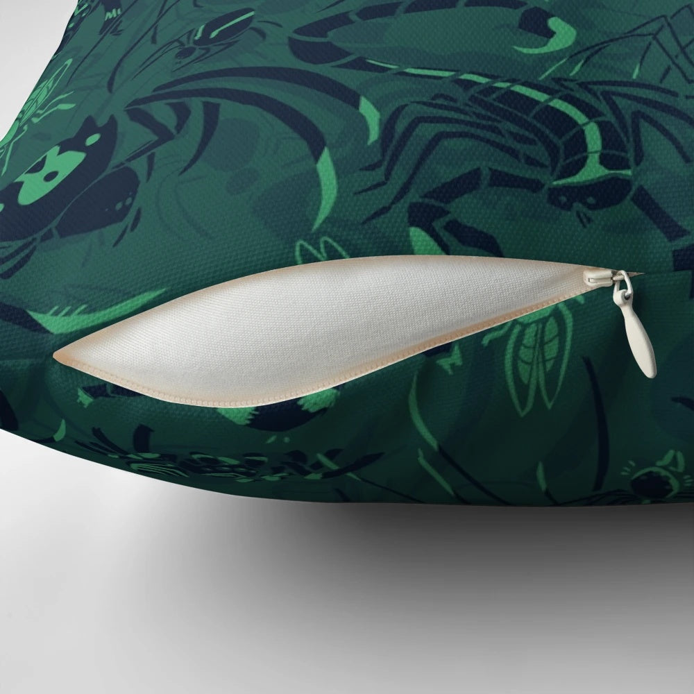 A plush, decorative pillow featuring a striking green pattern inspired by arachnids and other natural elements.