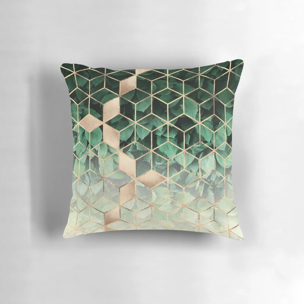 Pillow featuring an abstract pattern of green leaves and geometric cubes
