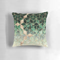 Pillow featuring an abstract pattern of green leaves and geometric cubes