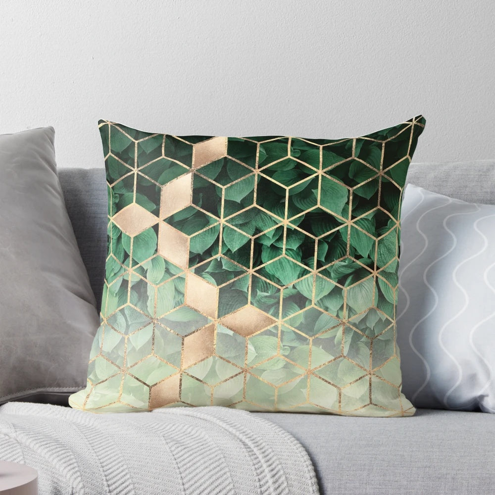 Pillow featuring an abstract pattern of green leaves and geometric cubes