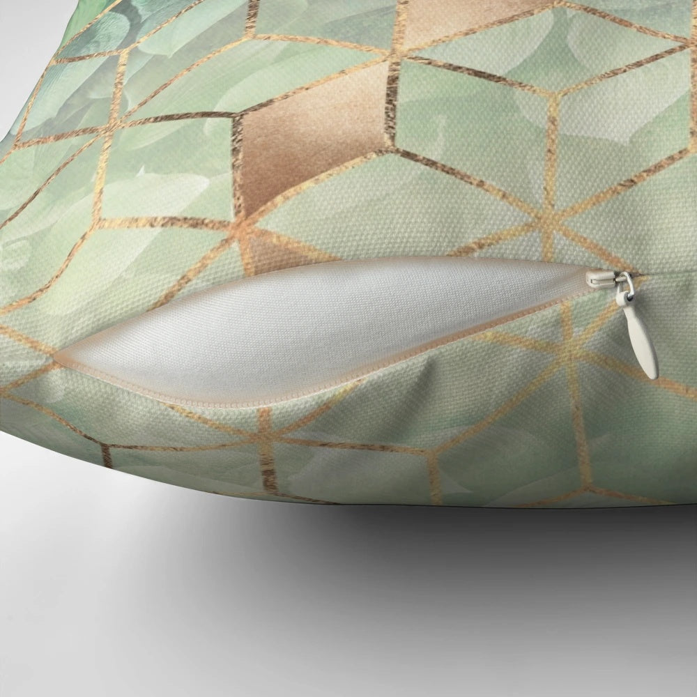 Pillow featuring an abstract pattern of green leaves and geometric cubes