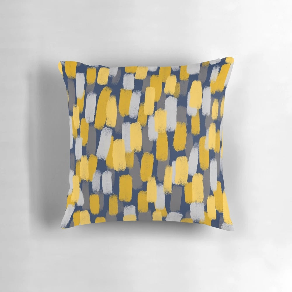 Navy blue decorative pillow with abstract grey and mustard yellow paint brush strokes