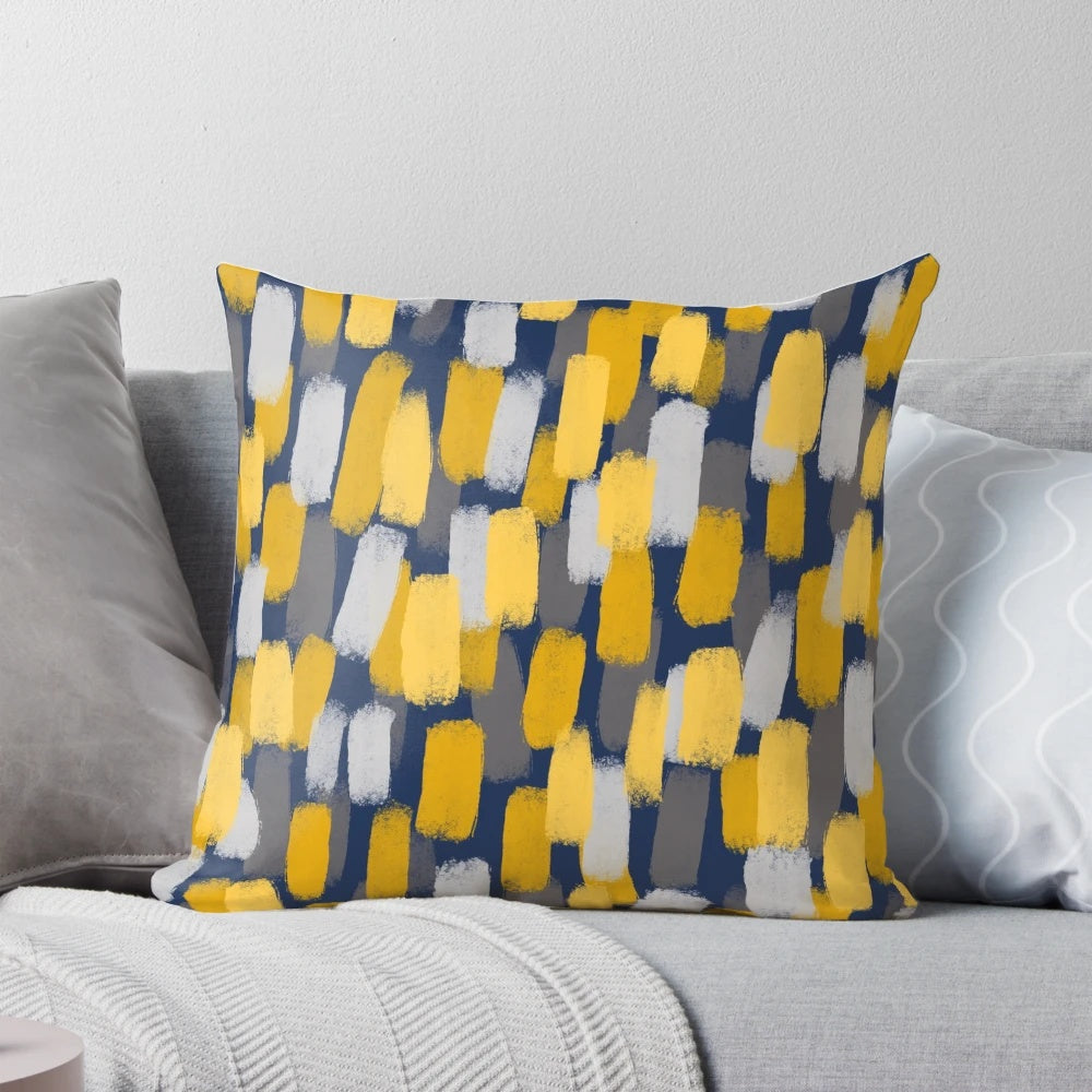 Navy blue decorative pillow with abstract grey and mustard yellow paint brush strokes
