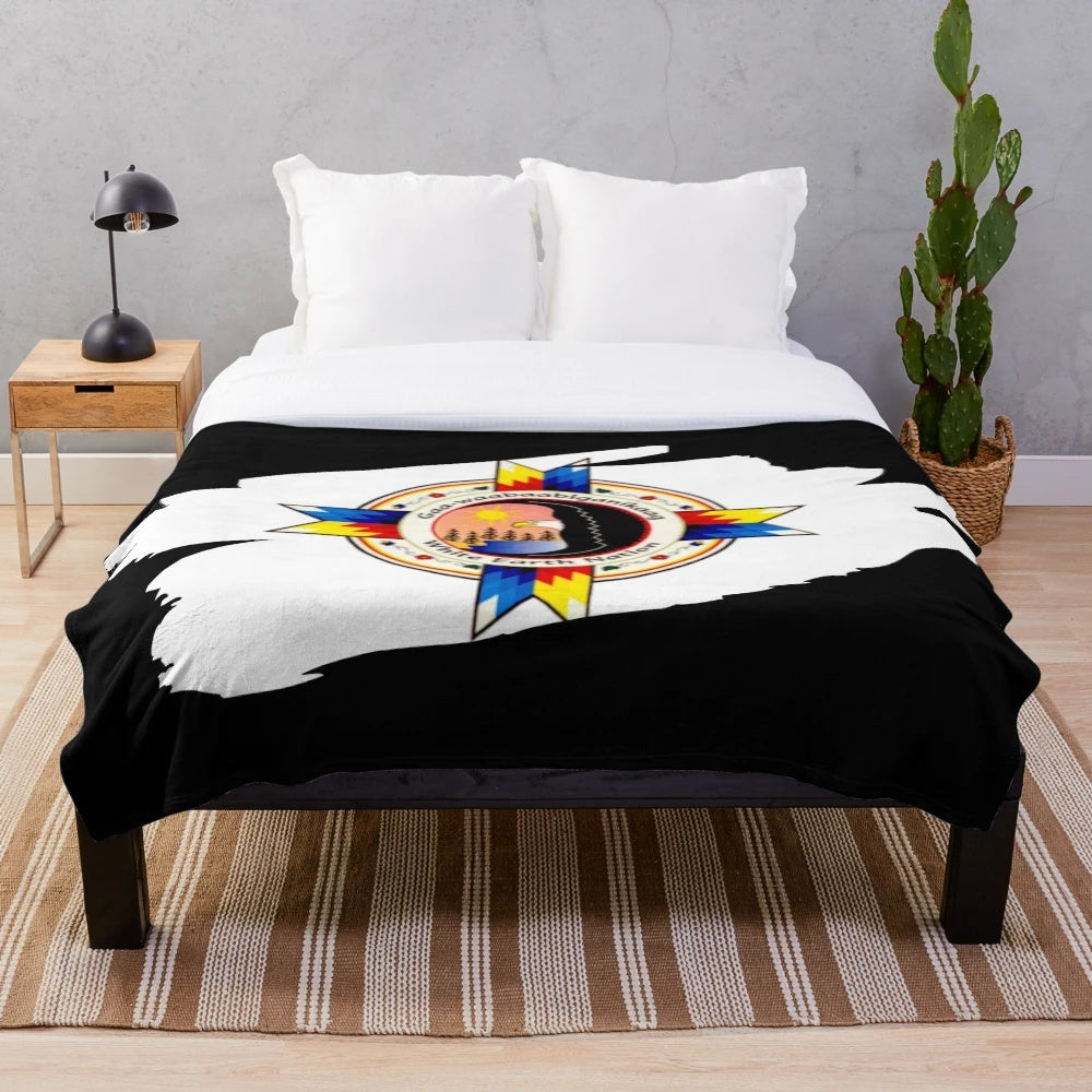 Plush blanket featuring the flag and tribal designs of the White Earth Nation
