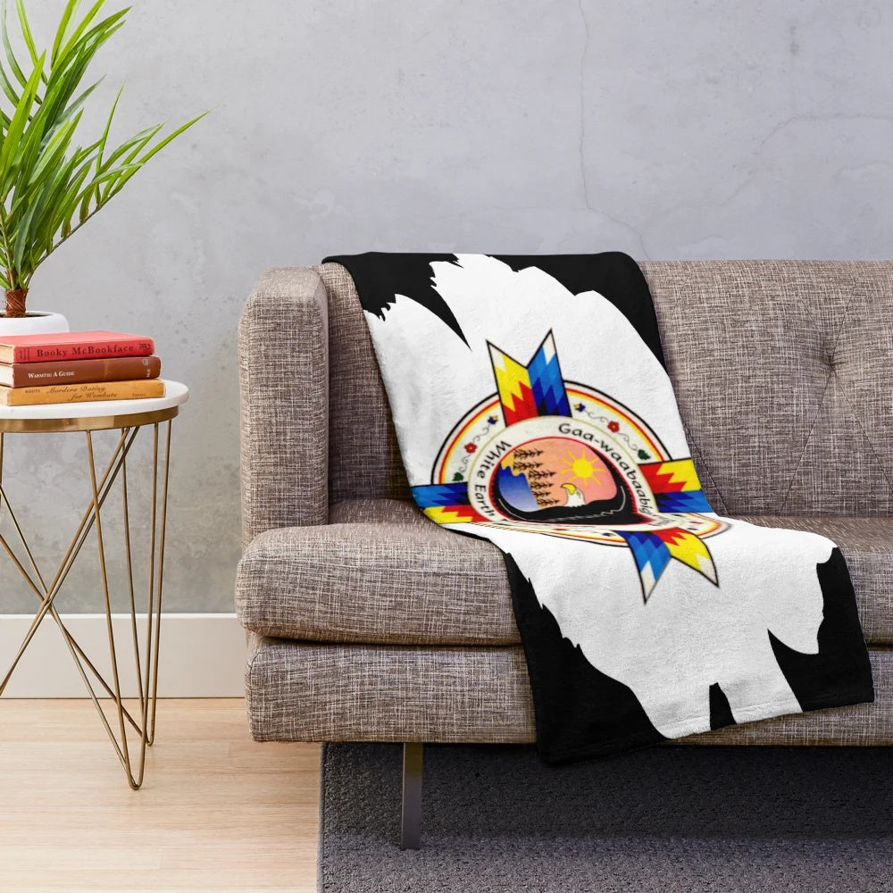 Plush blanket featuring the flag and tribal designs of the White Earth Nation