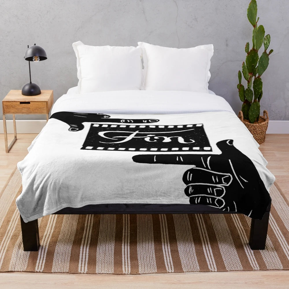 Plush blanket featuring a linocut design of the 'Fin' symbol from French cinema