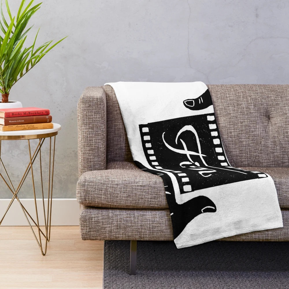 Plush blanket featuring a linocut design of the 'Fin' symbol from French cinema