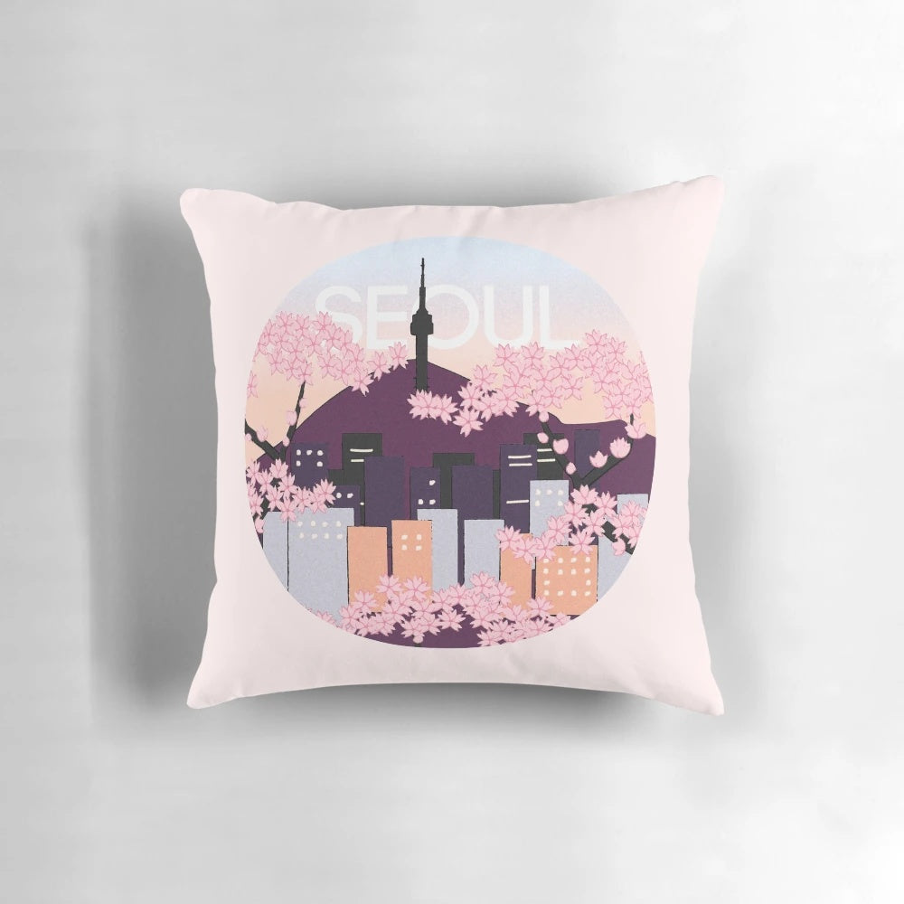 A plush pillow featuring an artistic depiction of Seoul Tower surrounded by vibrant Korean cherry blossoms.