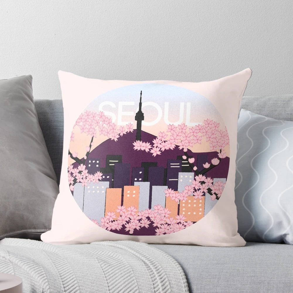 A plush pillow featuring an artistic depiction of Seoul Tower surrounded by vibrant Korean cherry blossoms.