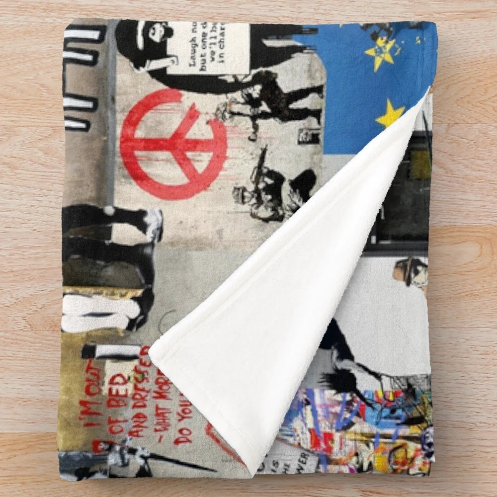 Banksy-inspired plush blanket featuring a collage of graffiti art, political imagery, and animal designs