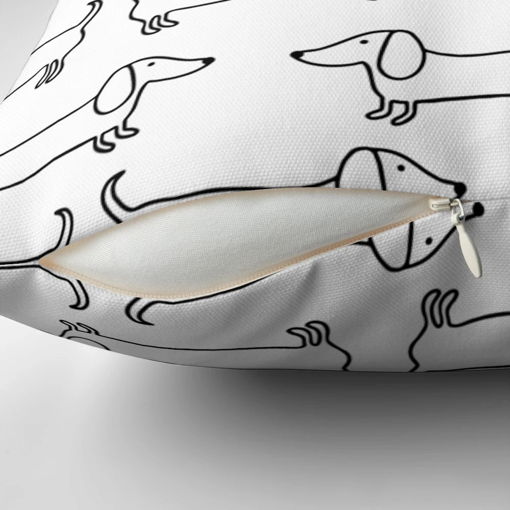 Black and white hand-drawn dachshund illustration on a decorative pillow