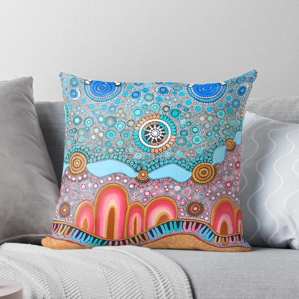 Pillow featuring indigenous-style dot painting design with ocean and landscape elements