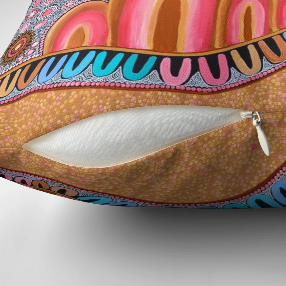 Pillow featuring indigenous-style dot painting design with ocean and landscape elements