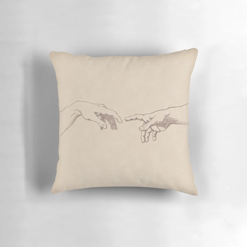 A decorative throw pillow featuring a sketch-style design inspired by Michelangelo's famous Renaissance artwork, "The Creation of Adam".
