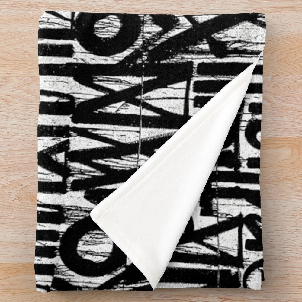Graffiti-inspired abstract plush blanket in gray tones