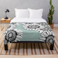 Plush blanket featuring a graphic design of wild flowers in black and white