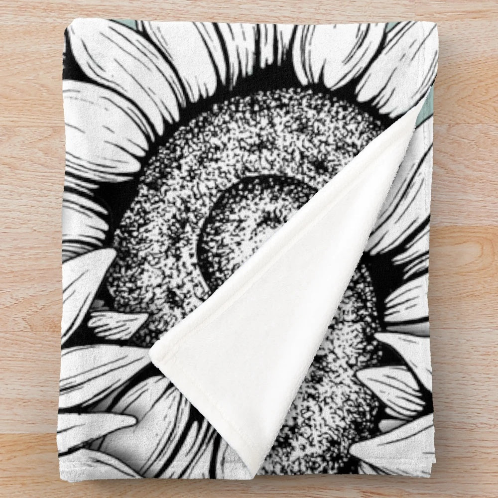 Plush blanket featuring a graphic design of wild flowers in black and white