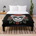 Soft and cozy plush blanket featuring an artistic sugar skull design with roses