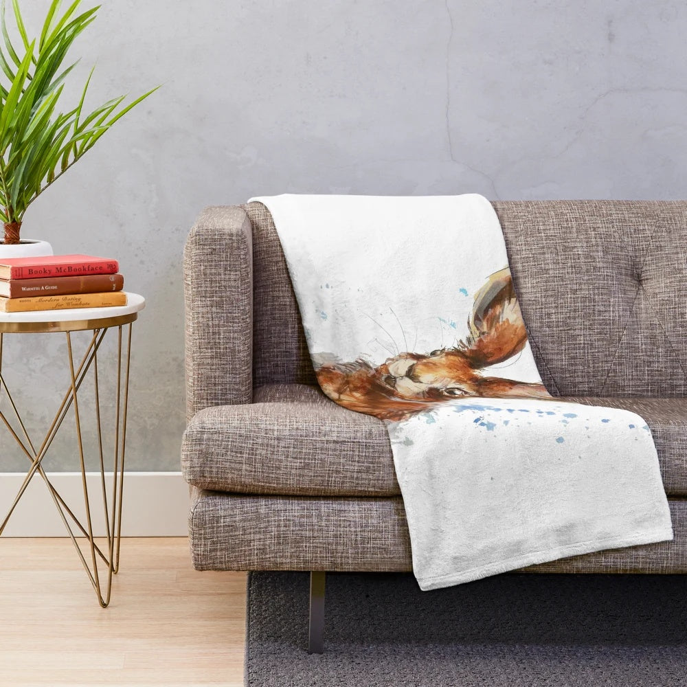 Watercolor painting of a hare on a soft, plush blanket