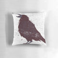 A stylishly distressed dark bird graphic throw pillow featuring original feather details.