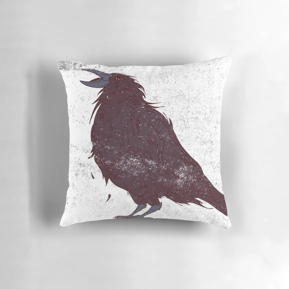 A stylishly distressed dark bird graphic throw pillow featuring original feather details.