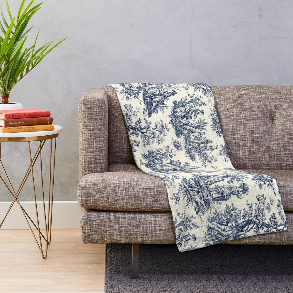 Soft, cozy plush blanket featuring a classic toile de jouy pattern in navy and white