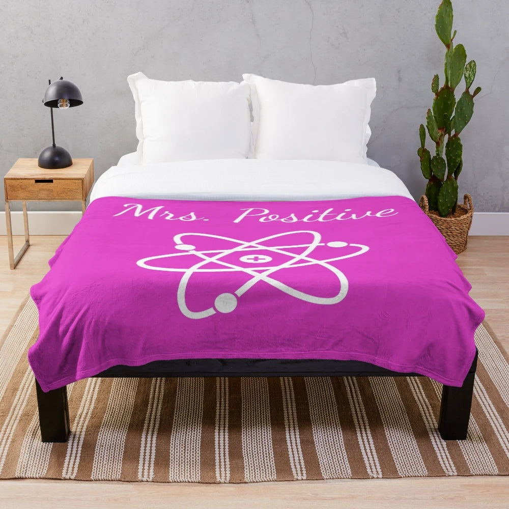 Plush blanket with atom design, science-themed home decor